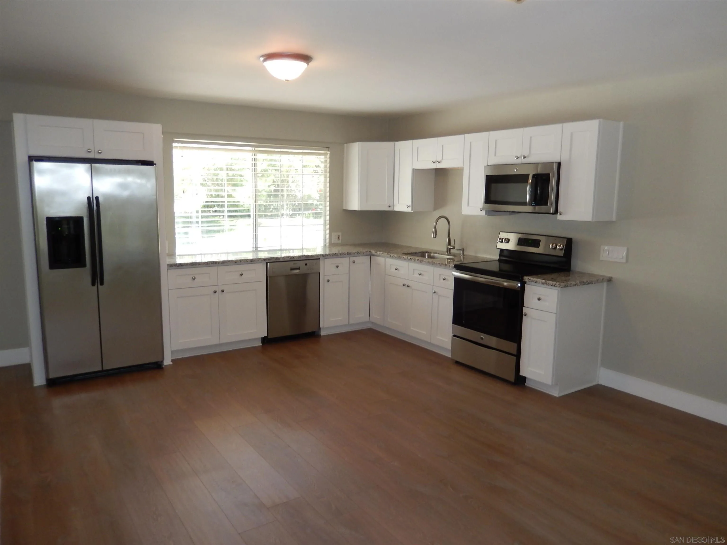 4959 Sleeping Indian Road Fallbrook, CA 92028 - Photo 18 of 22 a kitchen with stainless steel appliances granite countertop a stove a sink and a refrigerator