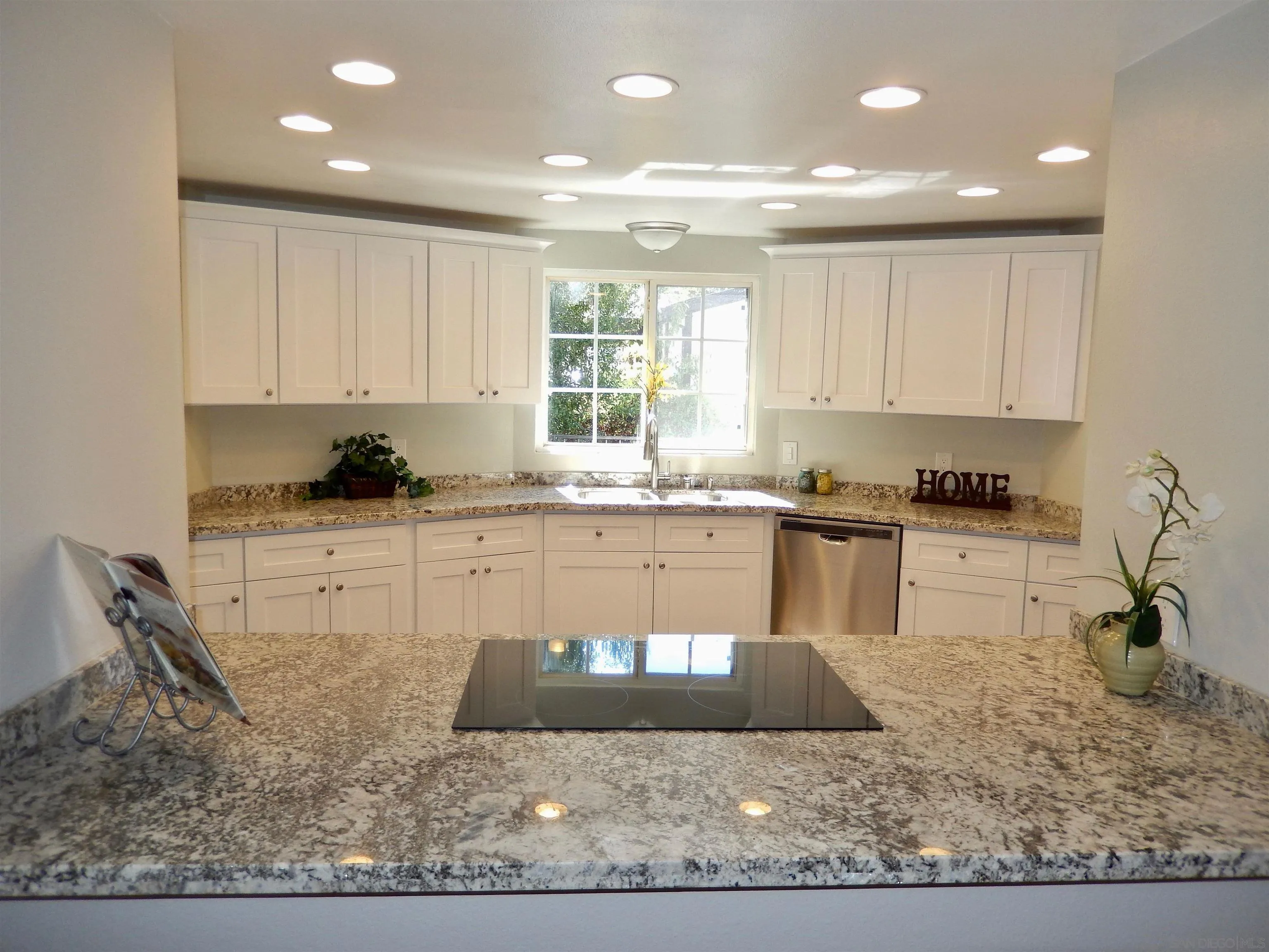 4959 Sleeping Indian Road Fallbrook, CA 92028 - Photo 4 of 22 a kitchen with stainless steel appliances granite countertop a stove a sink and a white cabinets