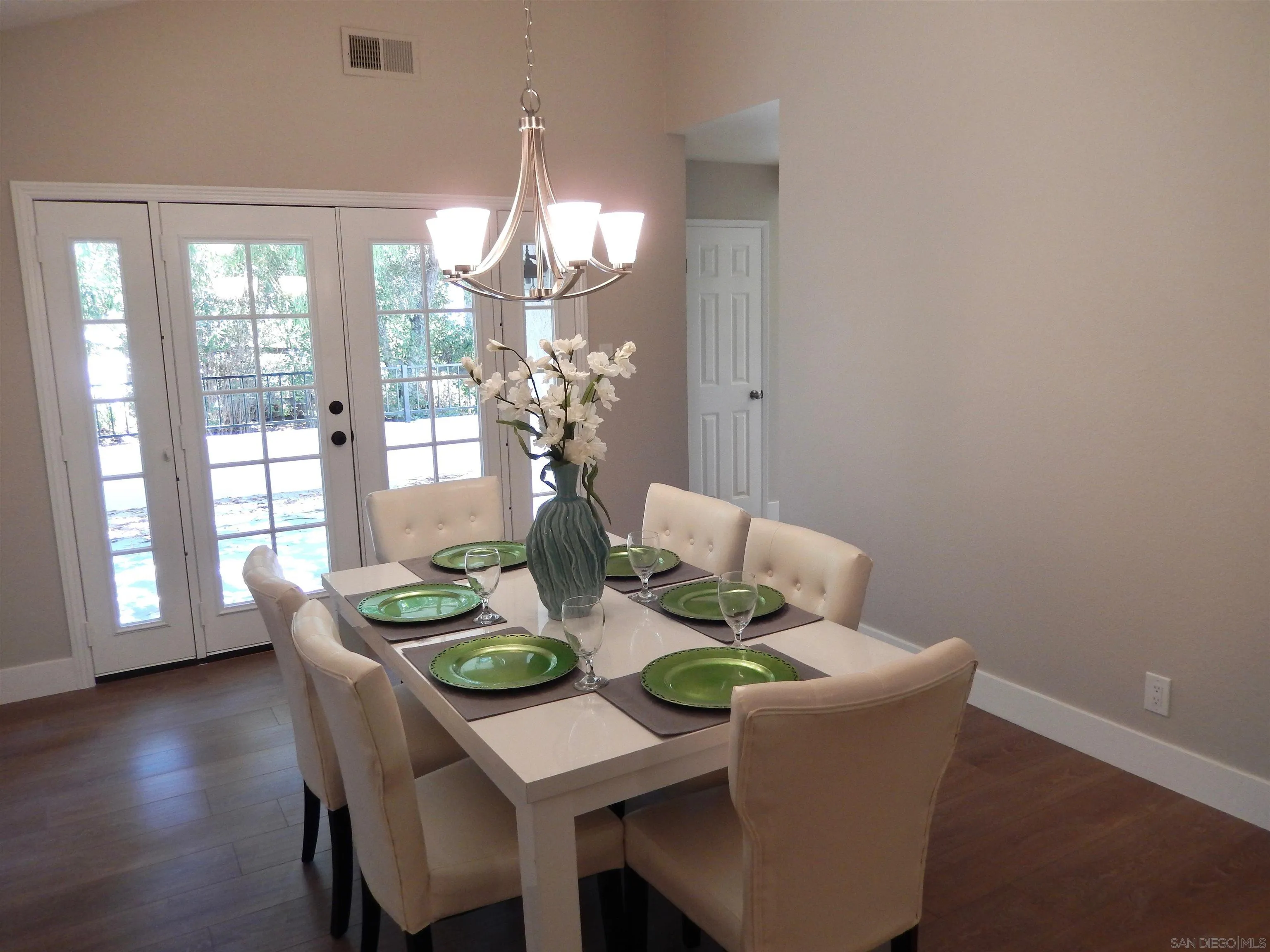 4959 Sleeping Indian Road Fallbrook, CA 92028 - Photo 8 of 22 a dining room with furniture a chandelier and wooden floor