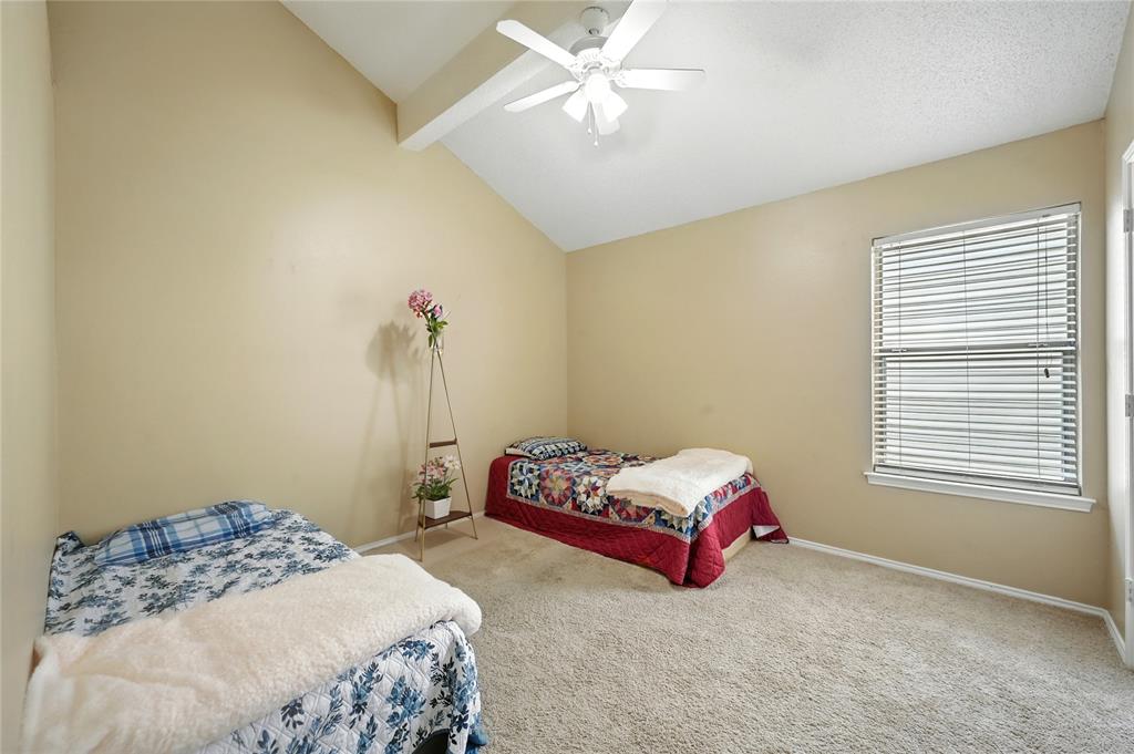 7741 Misty Ridge Drive North Fort Worth, TX 76137 - Photo 22 of 29 a bedroom with bed and a window