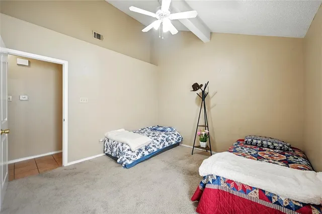 a bedroom with bed and a chandelier