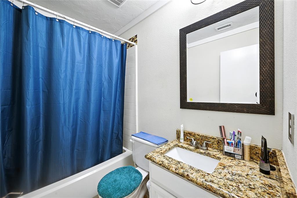 7741 Misty Ridge Drive North Fort Worth, TX 76137 - Photo 24 of 29 a bathroom with a granite countertop sink and a mirror