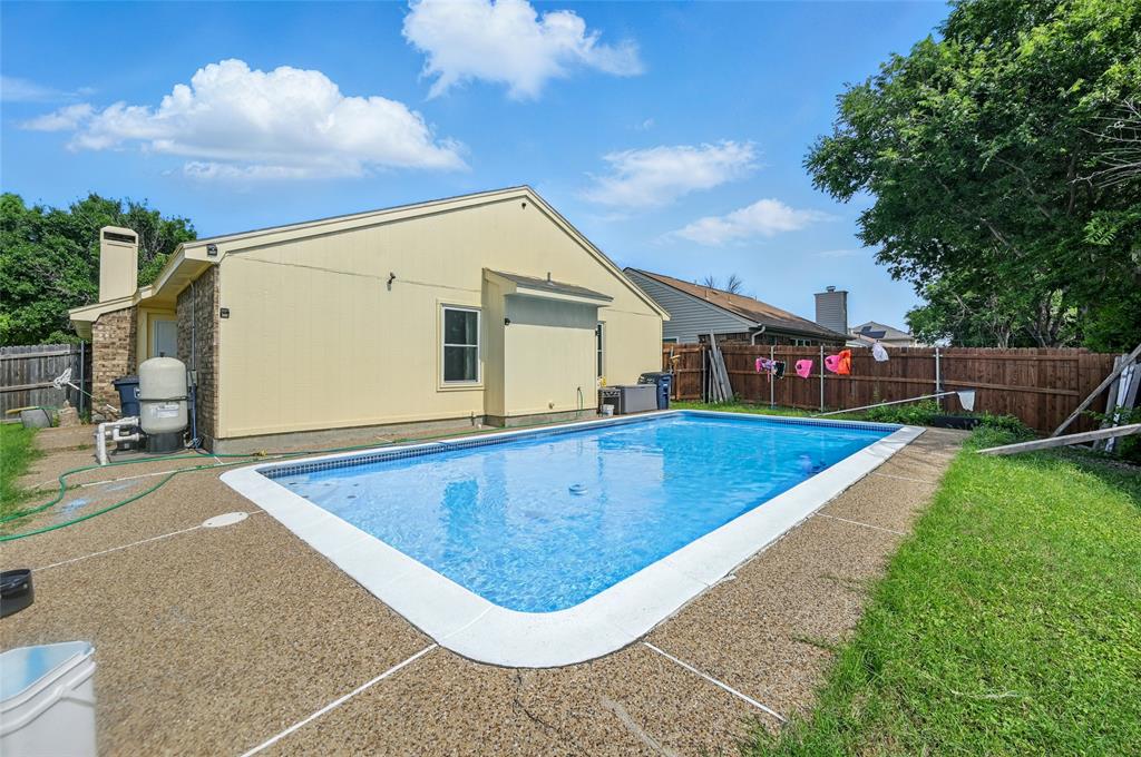 7741 Misty Ridge Drive North Fort Worth, TX 76137 - Photo 28 of 29 a view of swimming pool with a backyard