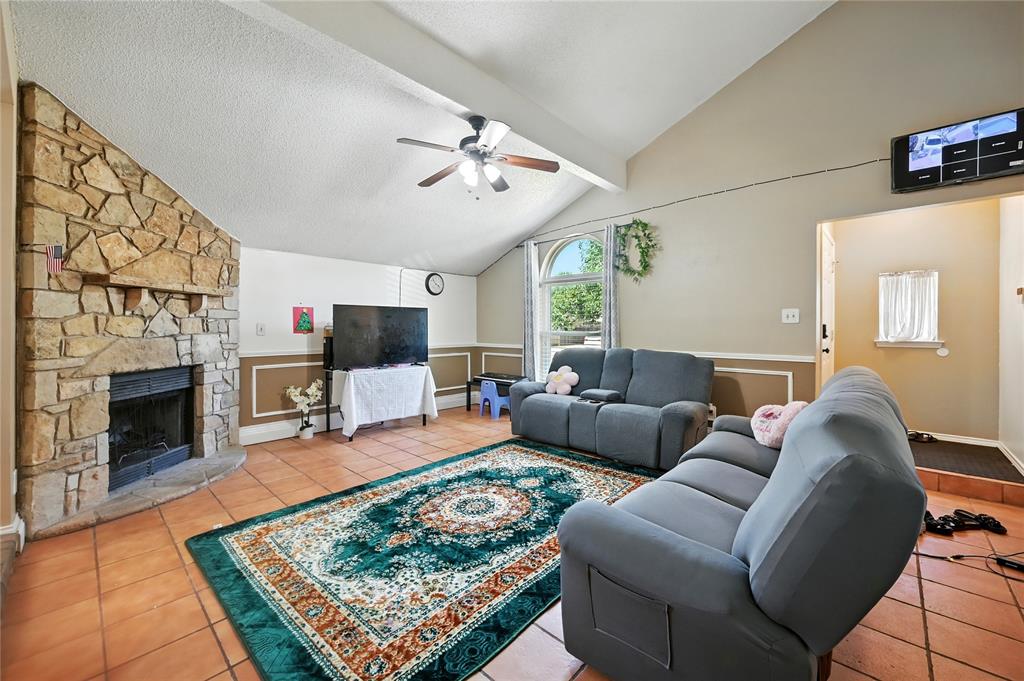 7741 Misty Ridge Drive North Fort Worth, TX 76137 - Photo 4 of 29 a living room with furniture a flat screen tv and a fireplace