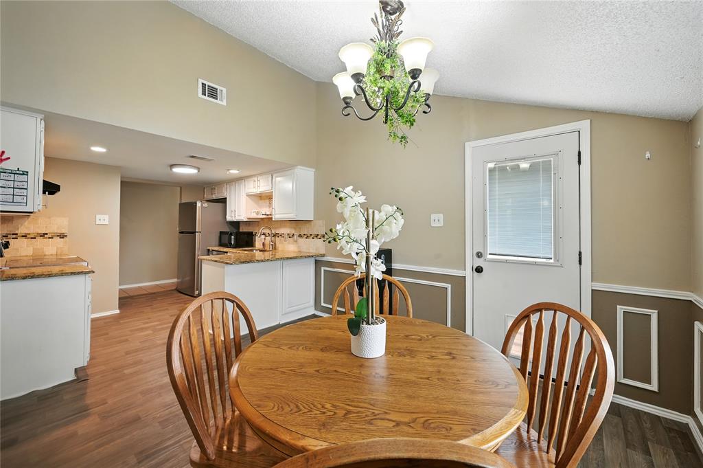 7741 Misty Ridge Drive North Fort Worth, TX 76137 - Photo 8 of 29 a dining room with furniture potted plants and wooden floor