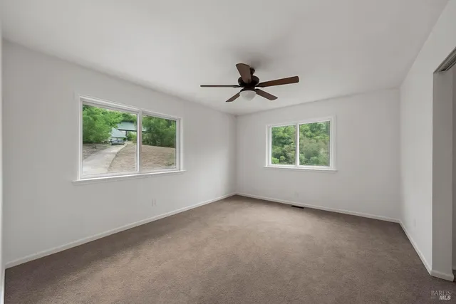 a view of an empty room with windows