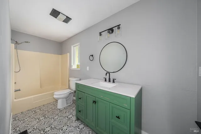 a bathroom with a toilet sink and mirror