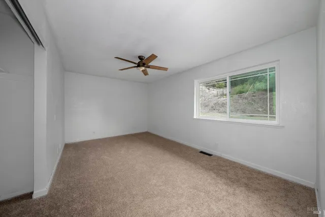 a view of room with window and ceiling fan