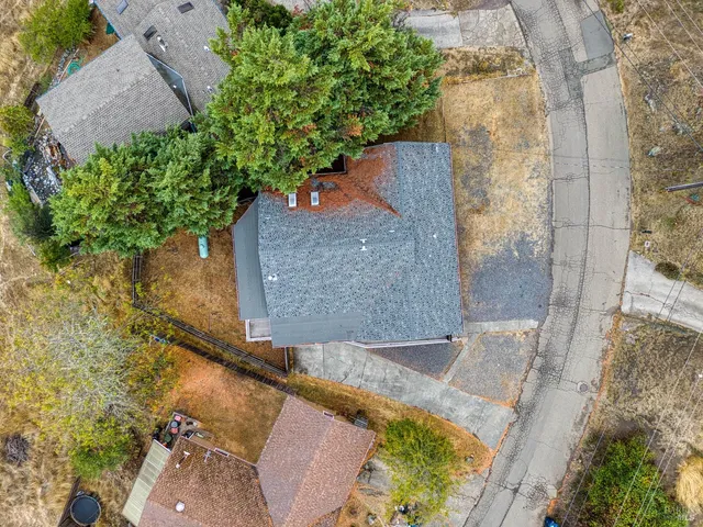 an aerial view of a house with a yard