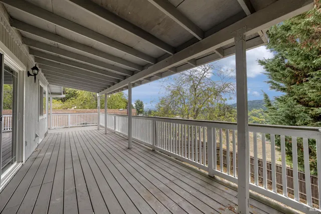 a view of a balcony with wooden floor