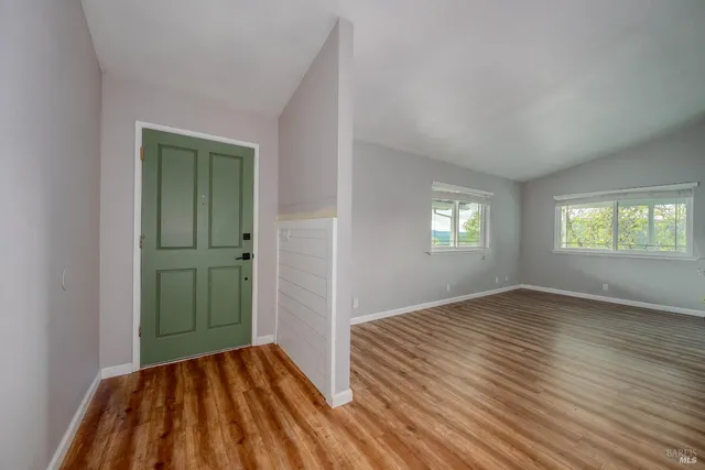 an empty room with windows and closet