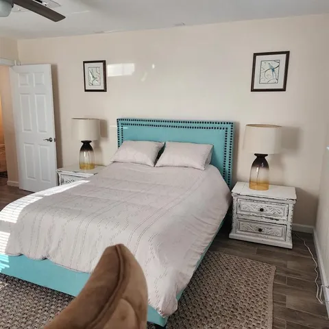 a bedroom with bed and painting on the wall
