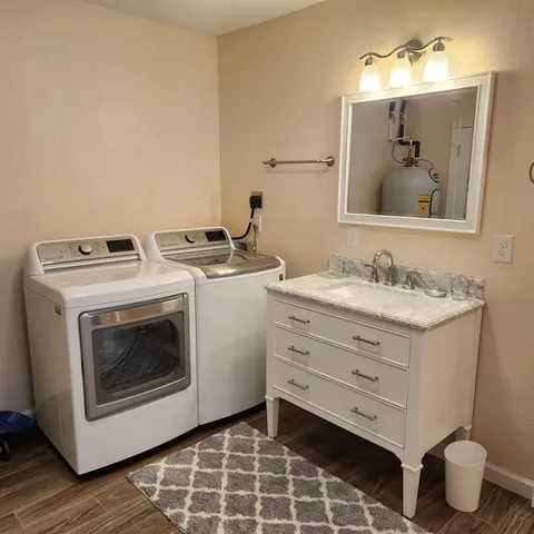 a bathroom with a sink toilet and mirror