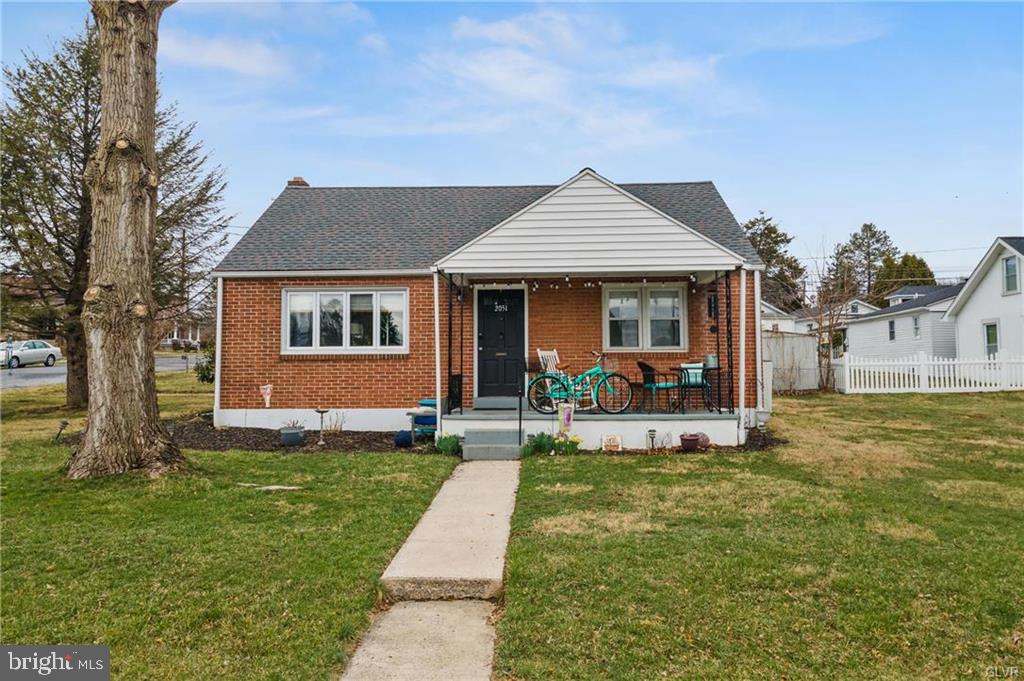 a front view of house with yard patio and green space