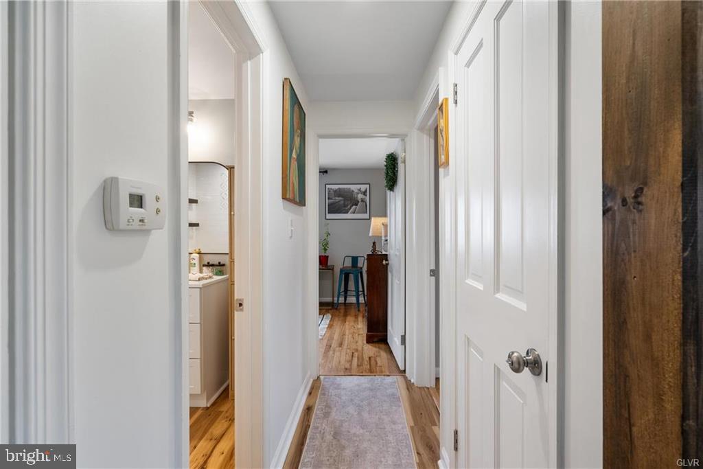 2051 Reading Avenue Reading, PA 19609 - Photo 11 of 45 a view of a hallway with wooden floor and a bathroom