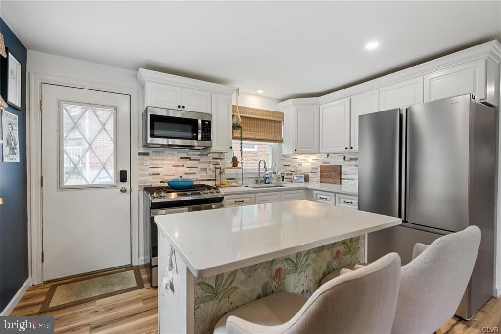 2051 Reading Avenue Reading, PA 19609 - Photo 7 of 45 a kitchen with stainless steel appliances granite countertop a refrigerator a stove microwave and sink