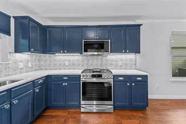 a view of kitchen and hall with wooden floor