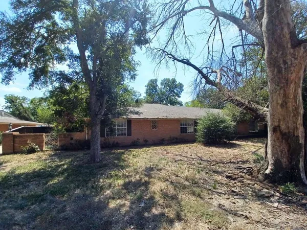 a house is covered with tall trees