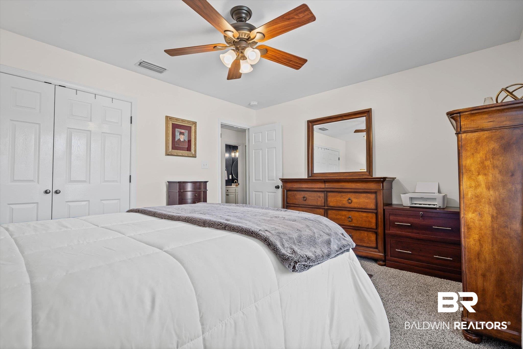 4567 Pine Avenue Saraland, AL 36571 - Photo 31 of 48 Bedroom with light carpet, a ceiling fan, and a closet