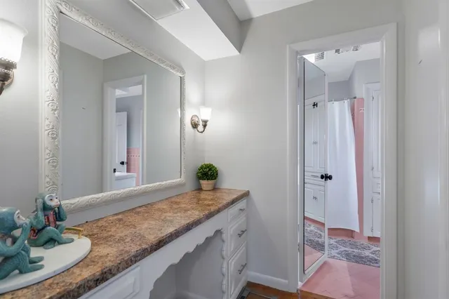 a bathroom with a granite countertop sink and a mirror