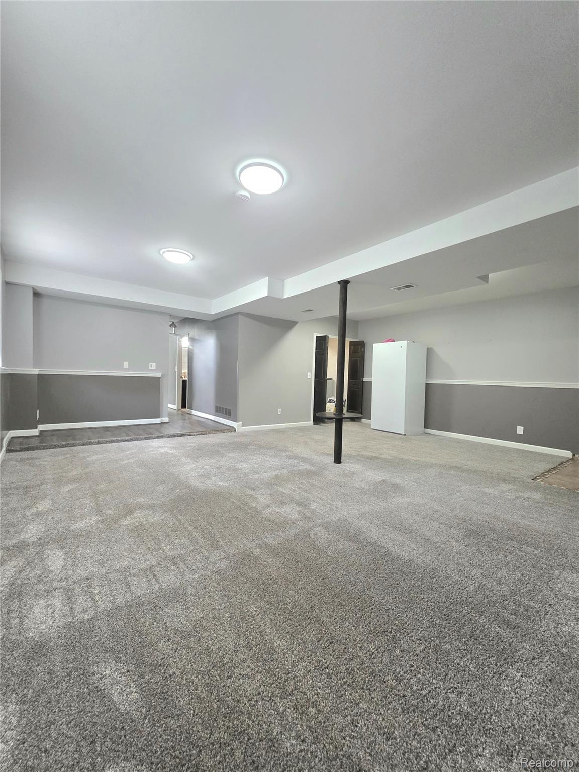 5158 Coldwater Road Columbiaville, MI 48421 - Photo 4 of 25 Spacious room featuring gray carpet flooring and recessed lighting