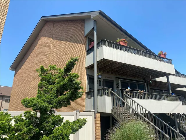a front view of house along with deck and outdoor seating