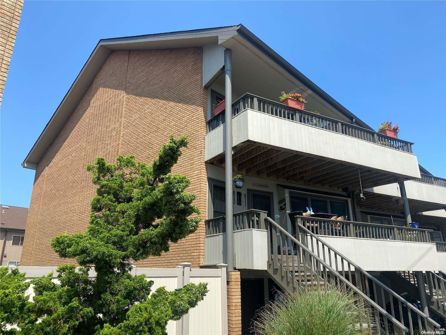 a front view of house along with deck and outdoor seating