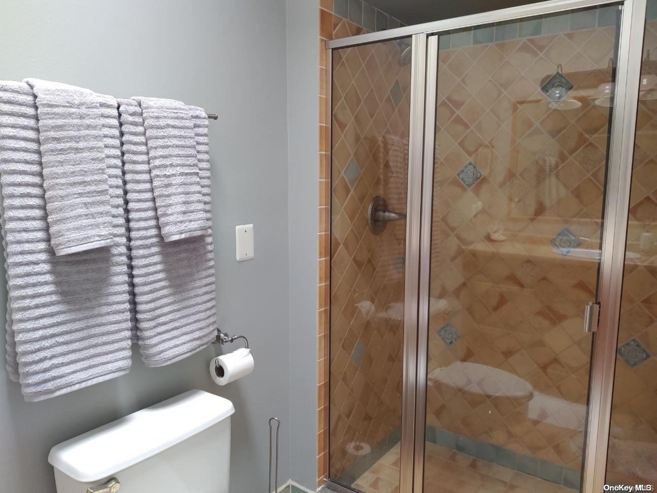 813 Shore Road Long Beach, NY 11561 - Photo 11 of 33 a bathroom with a shower and toilet