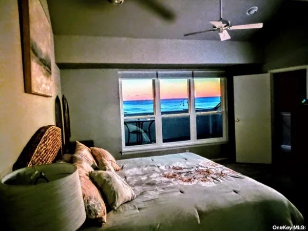 a bedroom with a bed and a television