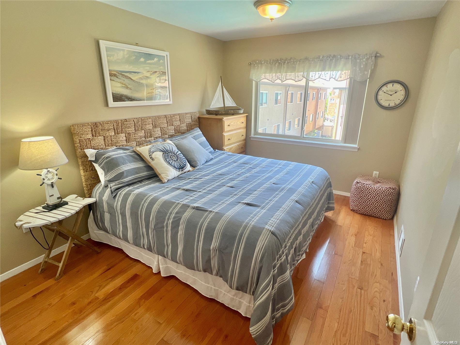 813 Shore Road Long Beach, NY 11561 - Photo 5 of 33 a bedroom with a bed and wooden floor