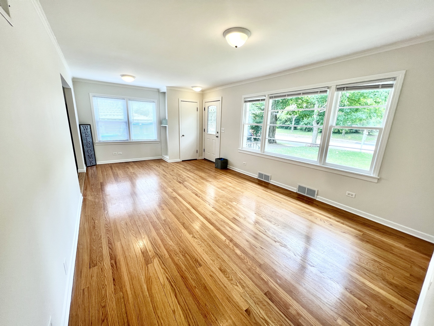 611 North Main Street Lombard, IL 60148 - Photo 3 of 17 an empty room with wooden floor and windows