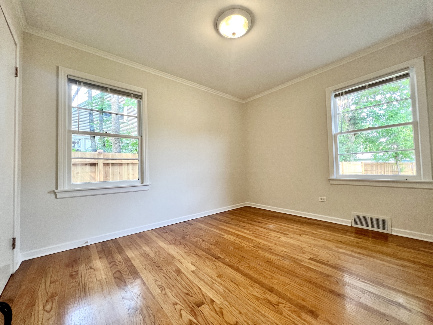 611 North Main Street Lombard, IL 60148 - Photo 6 of 17 an empty room with wooden floor and windows