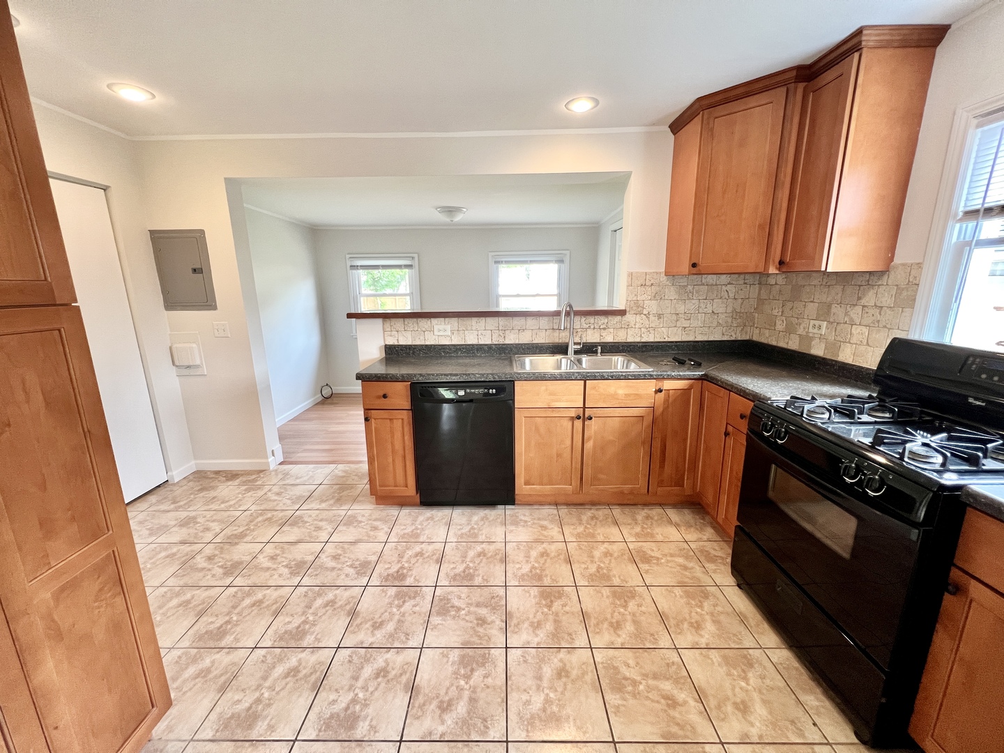 611 North Main Street Lombard, IL 60148 - Photo 9 of 17 a kitchen with stainless steel appliances granite countertop a sink stove and cabinets