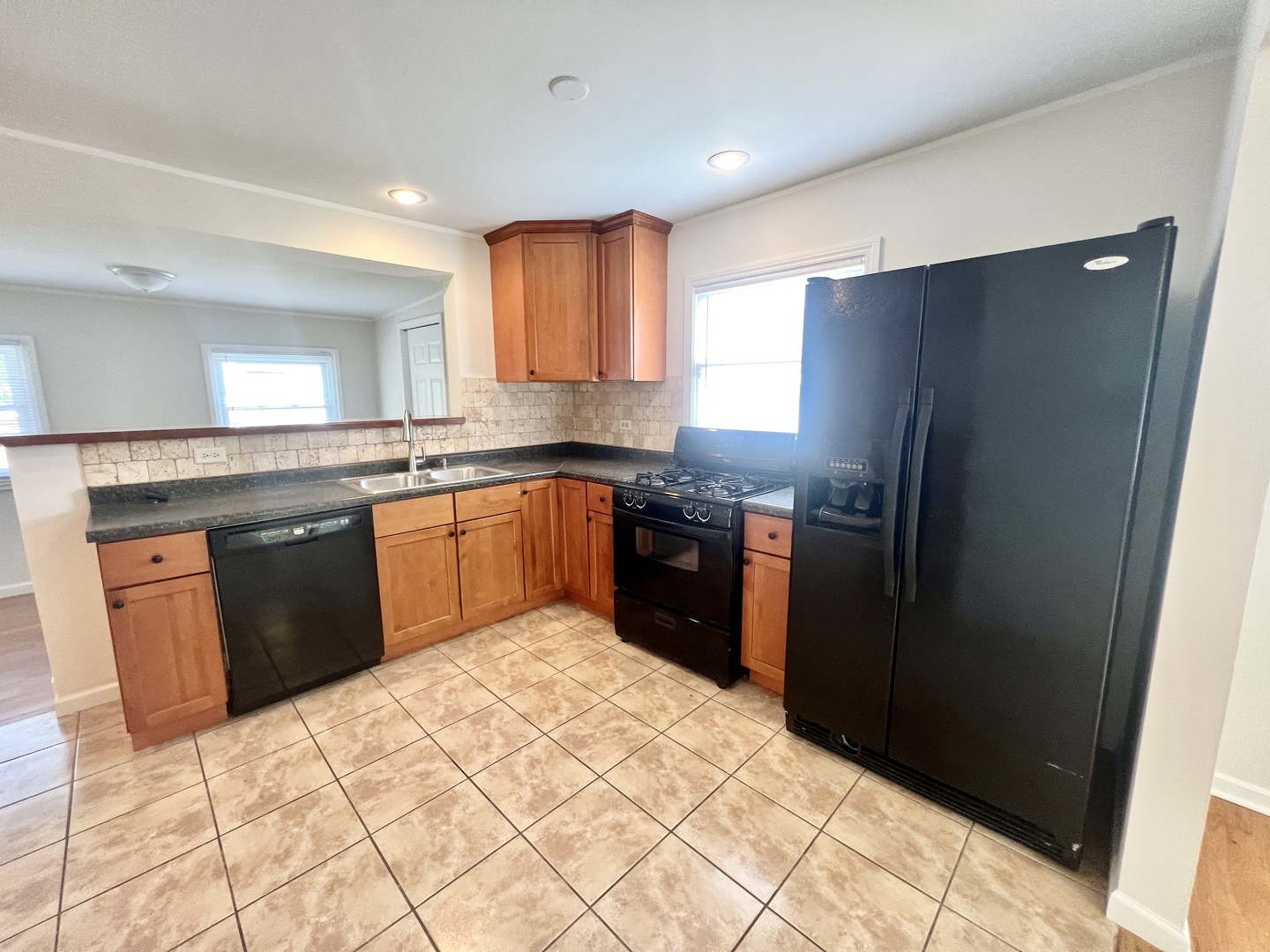 611 North Main Street Lombard, IL 60148 - Photo 10 of 17 a kitchen with stainless steel appliances granite countertop a refrigerator a sink a stove and dishwasher