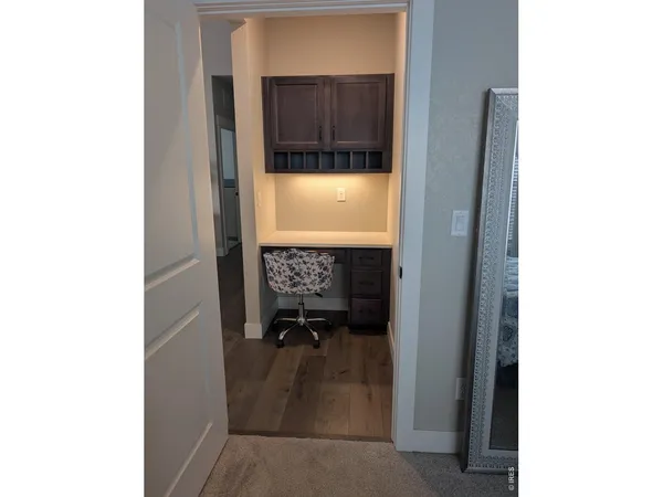 a view of a hallway with a room and a bathroom