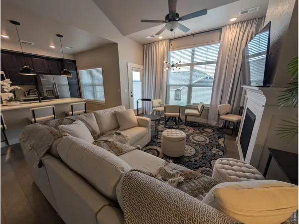 a living room with furniture and a large window