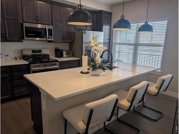 a kitchen with a kitchen island a stove and a wooden floor