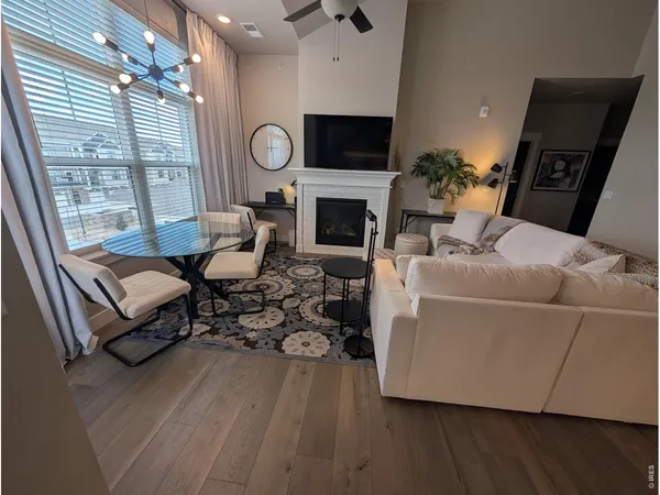 a living room with furniture a fireplace and a flat screen tv