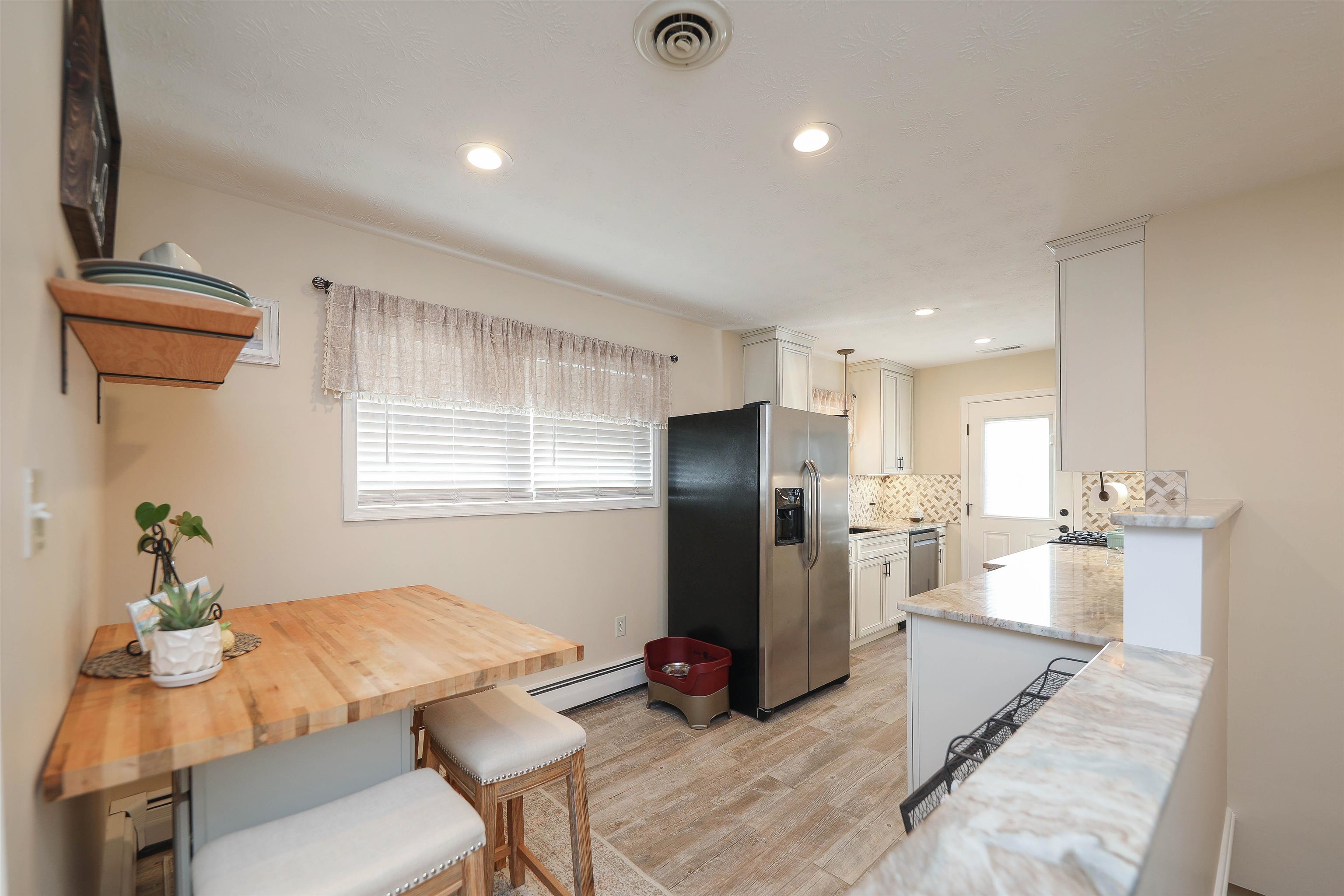 1198 Spaulding Street Staunton, VA 24401 - Photo 9 of 48 a kitchen with stainless steel appliances kitchen island granite countertop a refrigerator and a stove