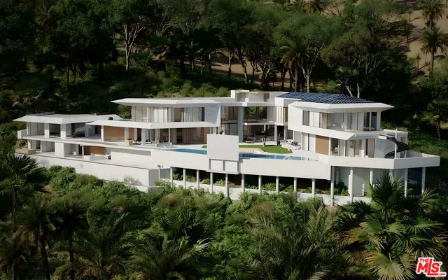 aerial view of a large building with a large windows and a yard