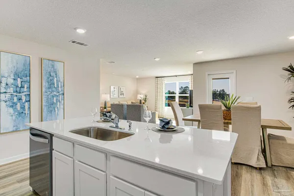 a kitchen with a sink appliances and cabinets
