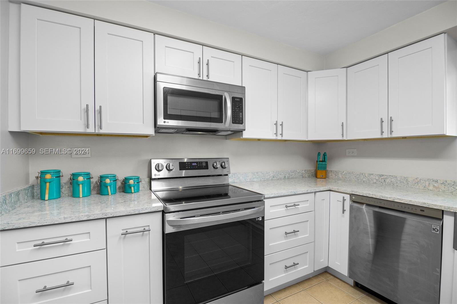 7951 Gulfstream Boulevard Marathon, FL 33050 - Photo 13 of 60 a kitchen with white cabinets and appliances