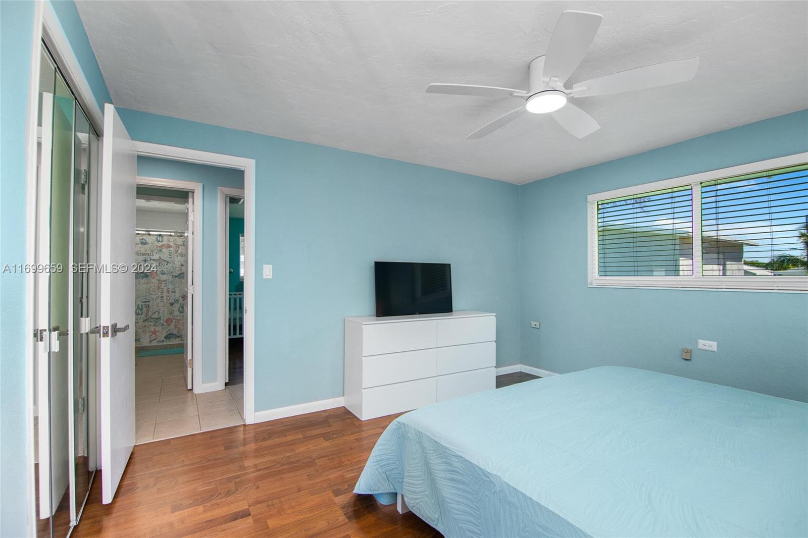 7951 Gulfstream Boulevard Marathon, FL 33050 - Photo 22 of 60 a bedroom with a bed and a flat tv screen on the dresser