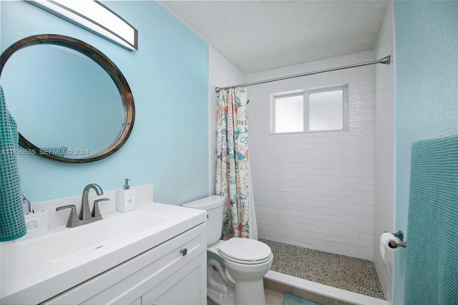 7951 Gulfstream Boulevard Marathon, FL 33050 - Photo 24 of 60 a bathroom with a sink a toilet and a mirror