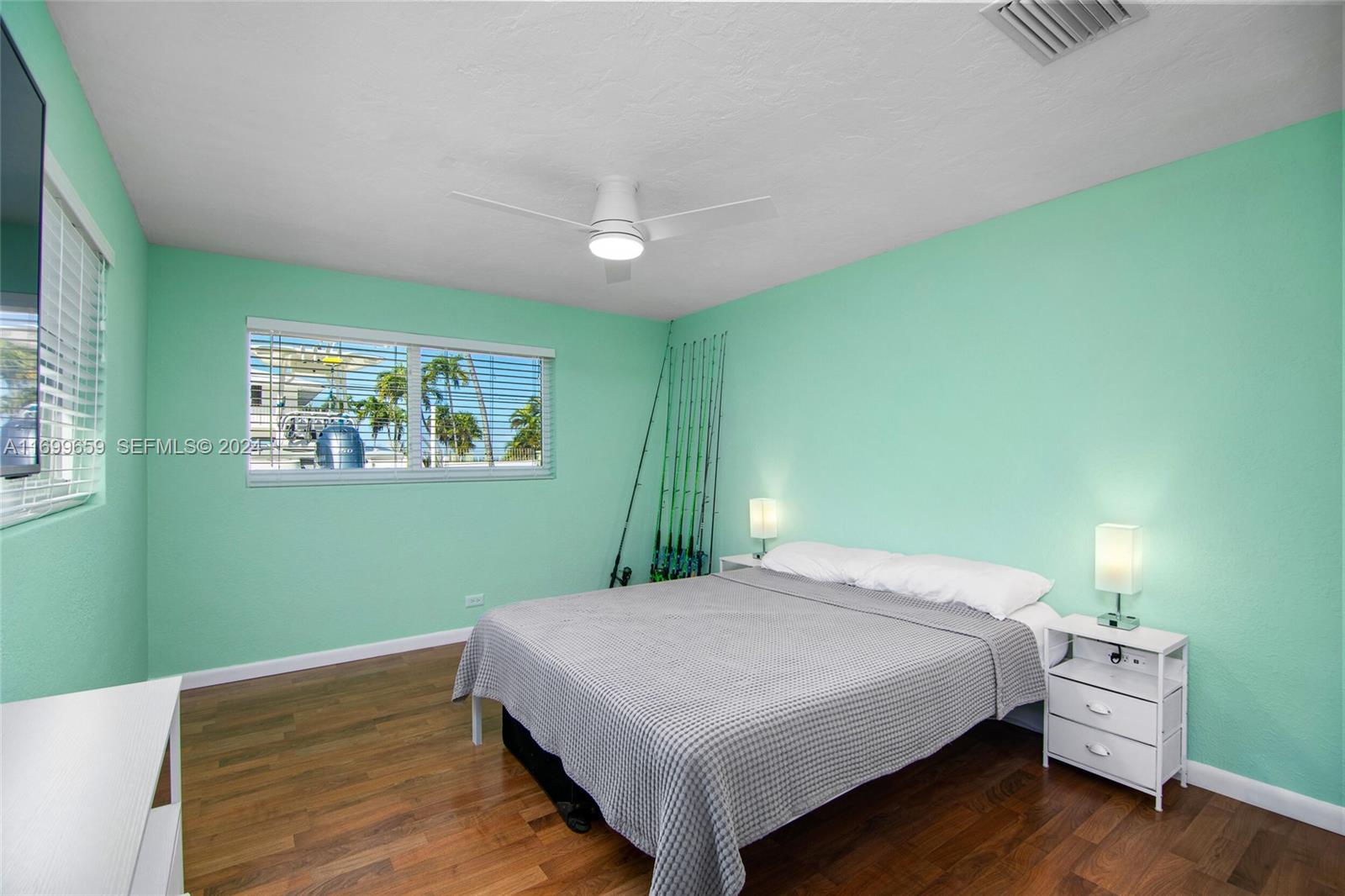 7951 Gulfstream Boulevard Marathon, FL 33050 - Photo 32 of 60 a bedroom with a bed and wooden floor