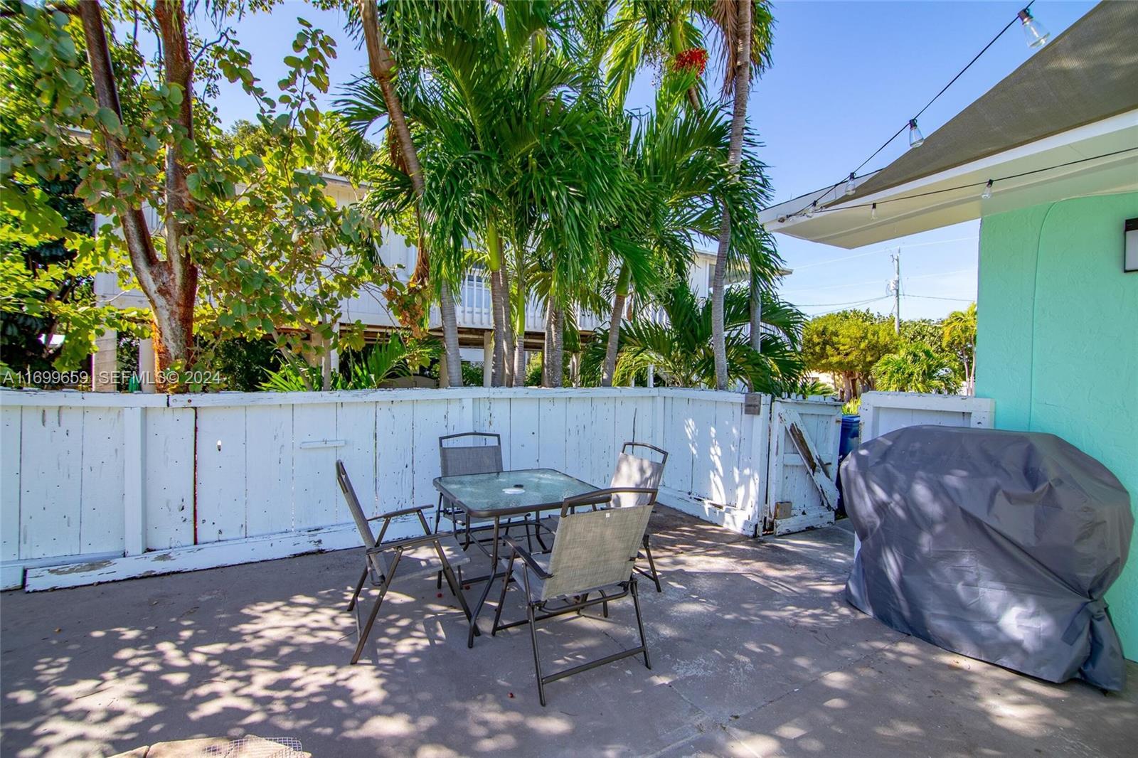 7951 Gulfstream Boulevard Marathon, FL 33050 - Photo 41 of 60 a view of a chairs and table in the backyard