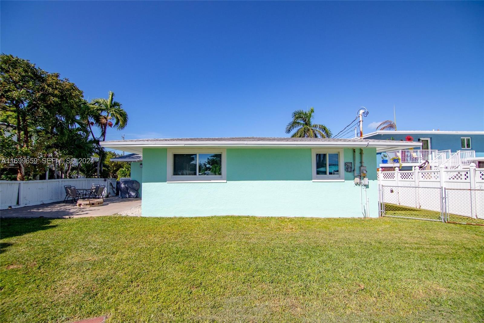 7951 Gulfstream Boulevard Marathon, FL 33050 - Photo 46 of 60 a front view of a house with a yard table and chairs