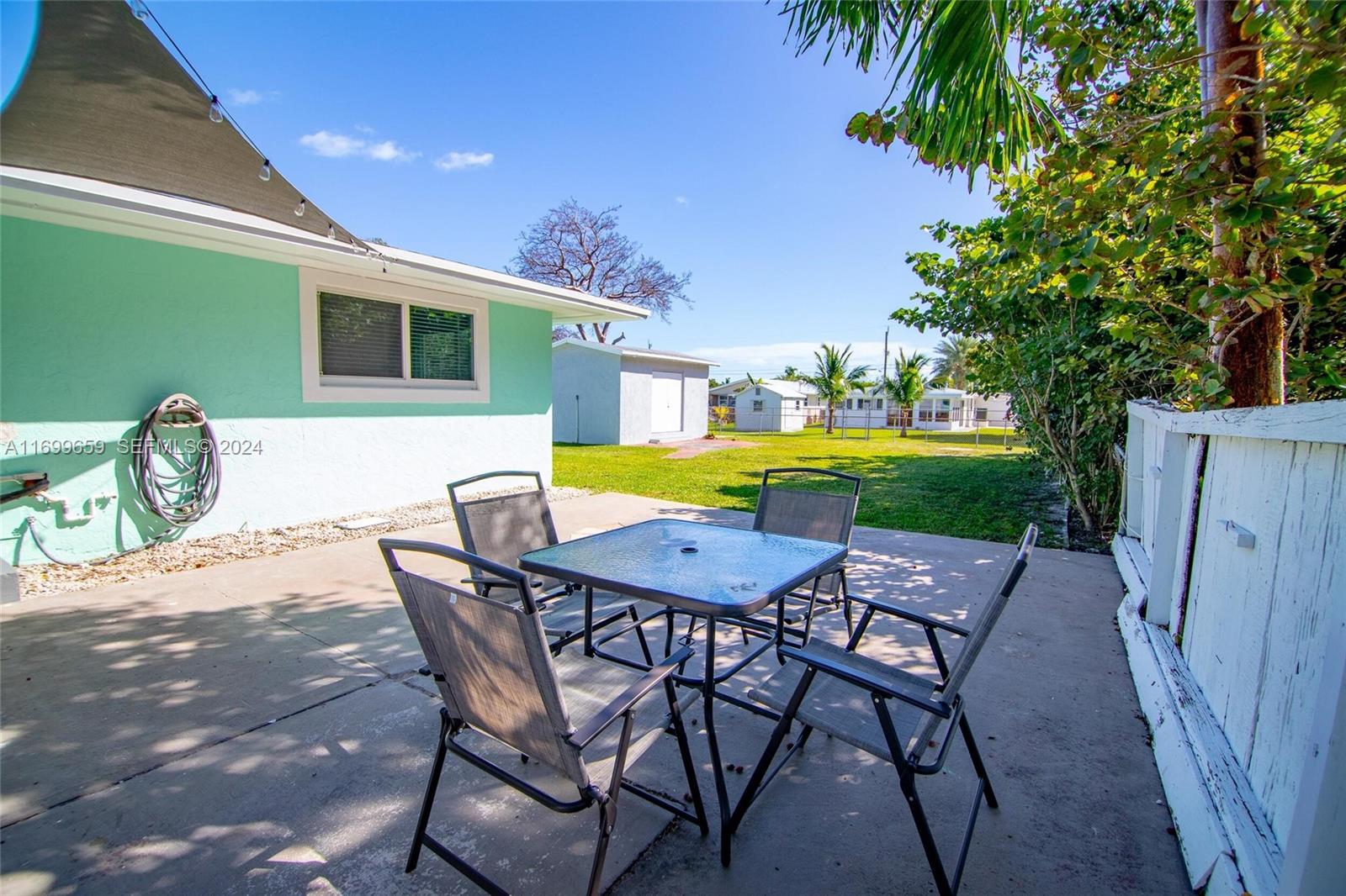 7951 Gulfstream Boulevard Marathon, FL 33050 - Photo 47 of 60 a patio with a table and chairs and potted plants