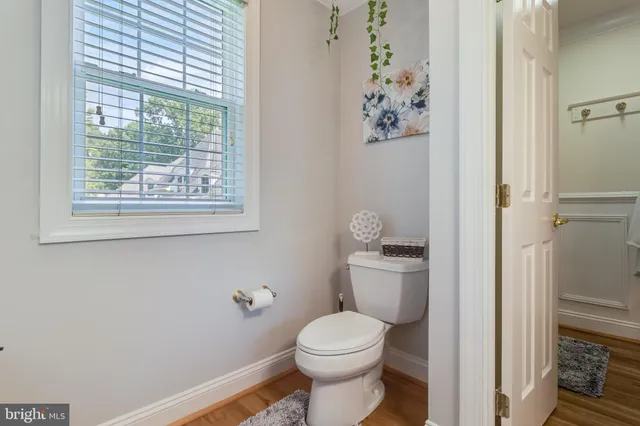 a bathroom with a sink vanity granite and toilet