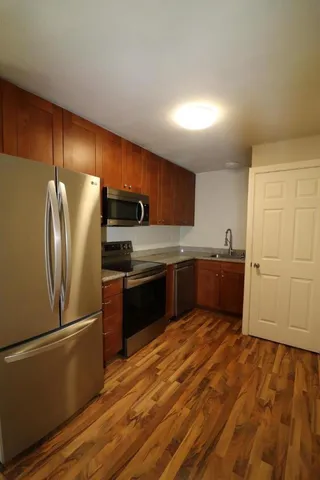 a kitchen with a refrigerator sink and cabinets